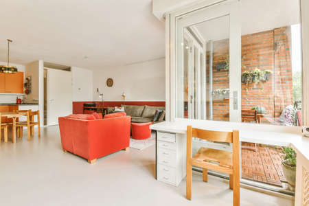 A room with large windows and a table adjacent to the windowの写真素材