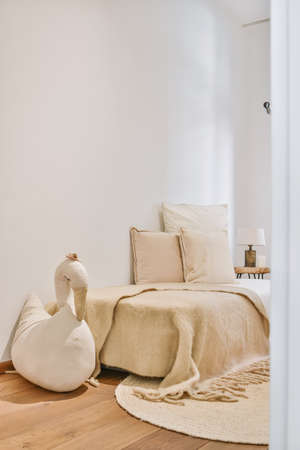 Small bedroom with a single bed in a minimalist styleの写真素材