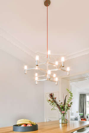 Spacious dining room with table and chairs in modern apartment in minimal styleの写真素材