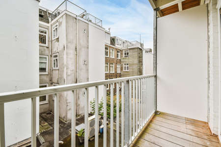 Attractive long narrow balcony with wooden handrailsの写真素材