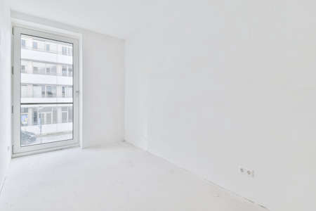 An absolutely white room with windows in an elegant apartmentの写真素材