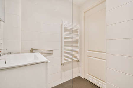 Attractive bathroom with sink and radiator on the wallの写真素材