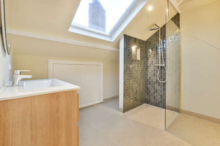 Interior of contemporary bathroom with shower and sink in minimal style in flatの写真素材