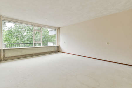 Empty room with big window and radiatorの写真素材