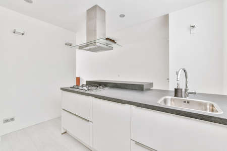 Mind-blowing kitchen area in light colors with light parquet flooringの写真素材