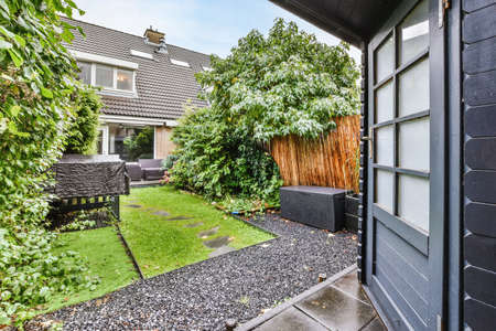 Mind-blowing courtyard with fresh lawn and stone pathの写真素材