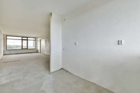 Delightful and cozy room with large windows and parquet floorsの写真素材