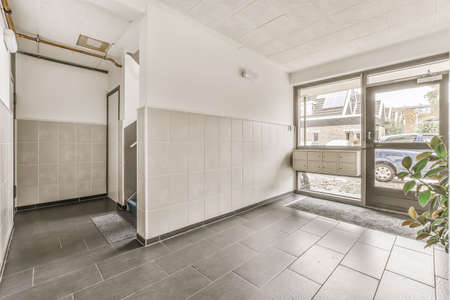 Modern entrance hall of the house with a glass door