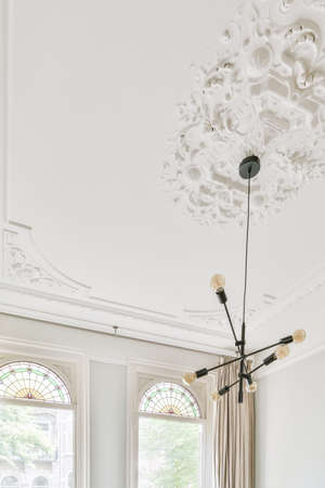 Graceful ceiling with a pattern and a chandelier in the middleの写真素材