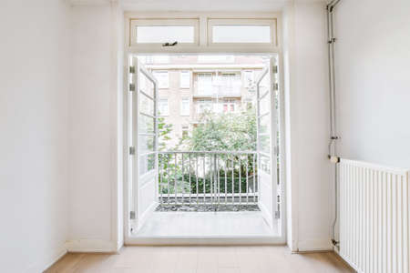 Bright room with open doors leading to the balconyの写真素材