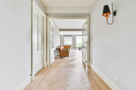 Long stunning hallway with wood flooring and white wallsの写真素材