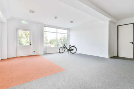 Huge bright room with large windows and a door to the outsideの写真素材