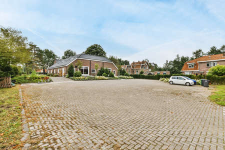 Cozy street with beautifully laid paving stones and lots of greenery