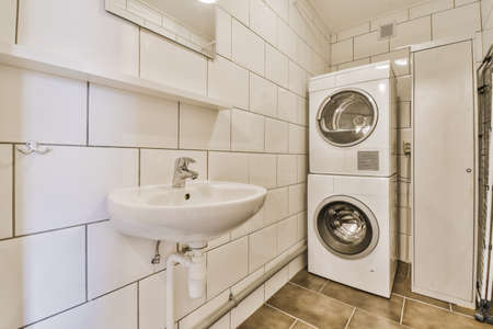 Laundry room with washing machine and long iron cabinetの写真素材