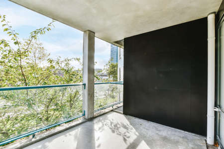 Large concrete balcony with glass railings and amazing viewの写真素材