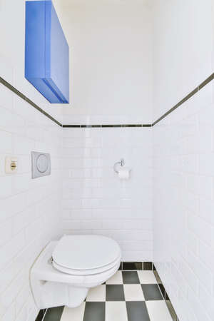 Small restroom with black and white checkerboard floorの写真素材