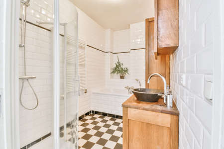 Delightful bathroom with white and black checkerboard floorの写真素材