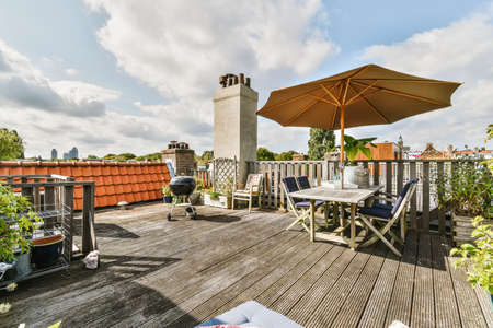 Exterior of the roof of the house with a delightful design with comfortable sun loungers and a tableの写真素材