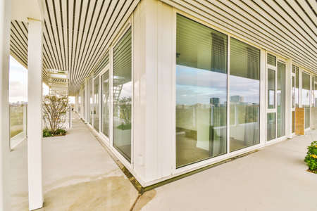 Enchanting balcony of a multi-storey building with glass railingsの写真素材