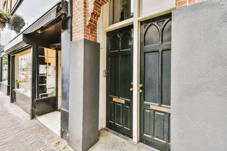 Entrance of the building with a wooden black door