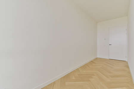Long narrow empty room with parquet floorの写真素材