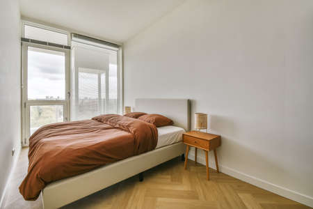 Luxurious bedroom with a brown fluffy bedspread on the bed