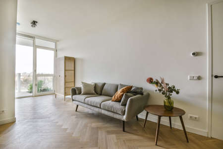 Gray comfortable and soft sofa with pillows in the living areaの写真素材