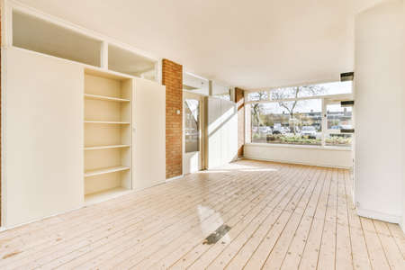 Large cozy empty room with window and wooden floorの写真素材