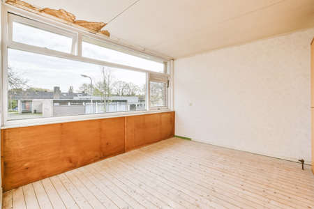 Large cozy empty room with window and wooden floorの写真素材