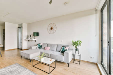 Stunning living area with gray plush sofa and glass coffee table