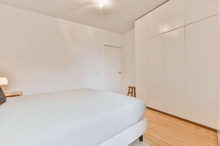 Interior of a cozy and bright bedroom with beautiful decorationの写真素材