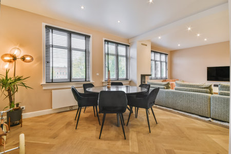Stylish and cozy dining area with a round black table and black chairs
