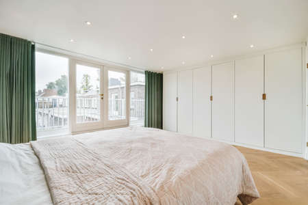 Elegant and cozy bedroom with a double soft bed