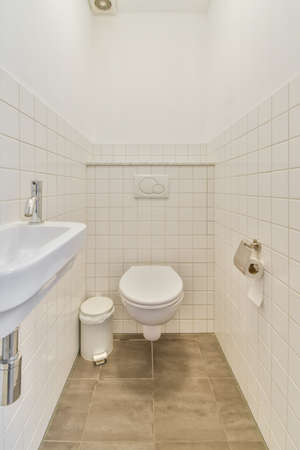 Restroom with sink and wall-hung modern toilet