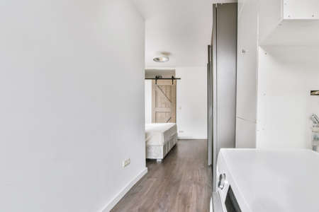 Long narrow light corridor with a washing machine