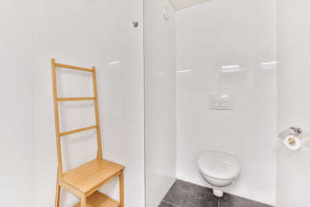 Stylish small bathroom with long back wooden stool