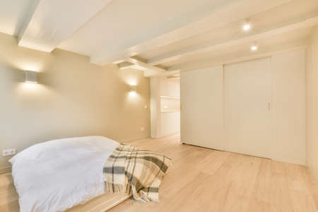 Modern home interior design of small bedroom with white walls and soft cozy bed and minimalist style...