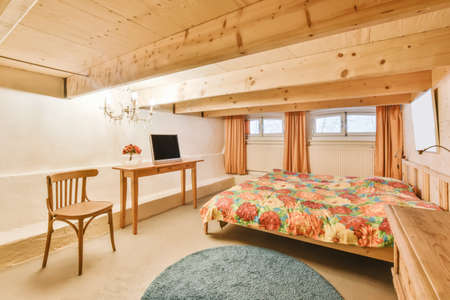 Attic room with a wooden ceiling and a huge soft bed