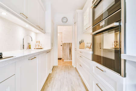 Long narrow kitchen with kitchen units on both sides