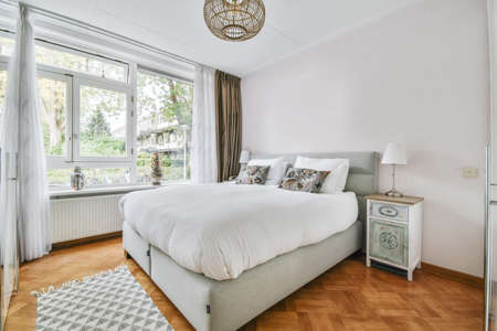 Cozy bedroom with the softest bed covered with a soft fluffy bedspread
