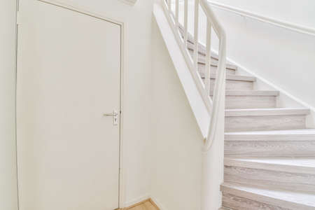 Lovely staircase with light parquet floor and door