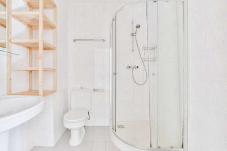 Bright bathroom with walk-in shower in a delightful apartmentの写真素材