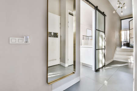 An elegant corridor with a large full-length mirror