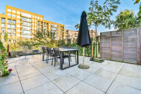 Graceful courtyard of the house with a large black table and chairs