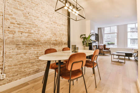 Dining area with velvet soft brown chairs and an unusual hanging chandelier
