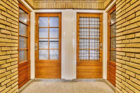 The entrance of the building with a wooden doorの写真素材