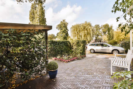 Lovely courtyard with greenery and a parked car