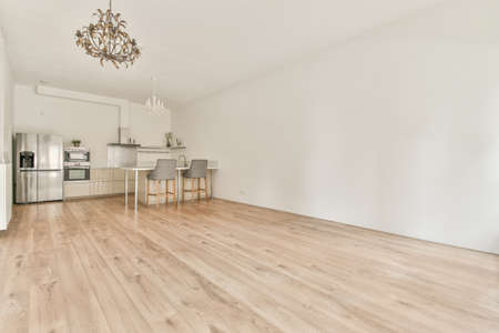 Modern kitchen with a worktop next to two high-legged chairs
