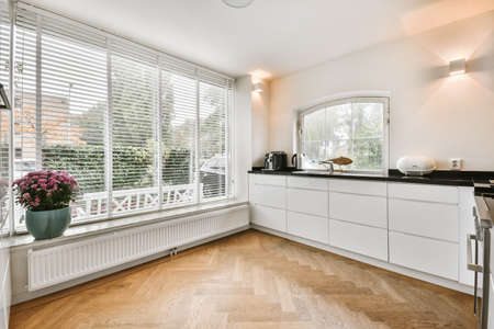 Lovely kitchen with white kitchen unit and parquet floor