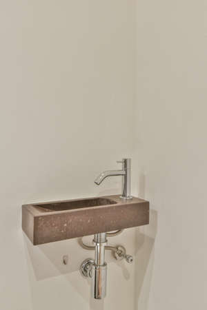 Sink with tap in contemporary restroom at home
